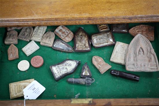 A collection of Buddhist terracotta amulets, chest 82cm